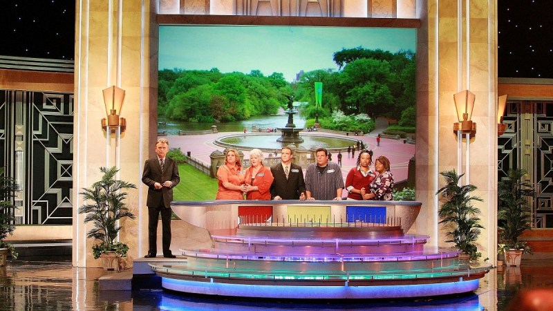 The set of Wheel of Fortune featuring Pat Sajak and several contestants