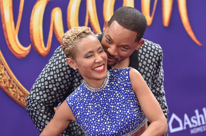 Will Smith standing behind Jada Pinkett Smith, hugging her