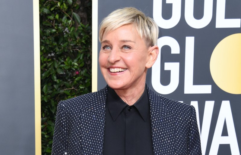 Ellen DeGeneres smiling in a blue jacket