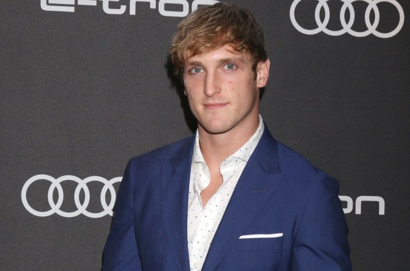 Logna Paul smiling and wearing a blue suit.