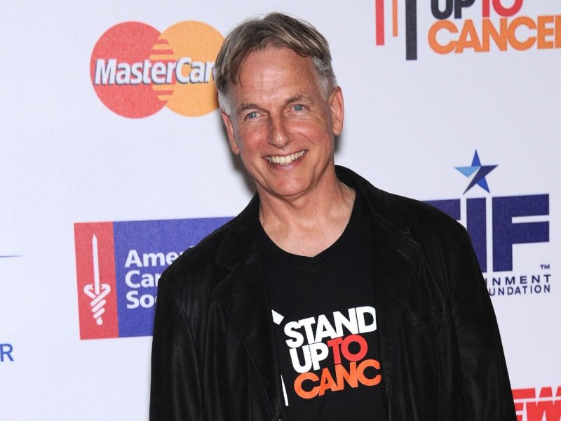 Mark Harmon wearing a black t-shirt and a black jacket.