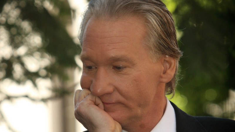 Bill Maher rests his chin on his hand during a public event