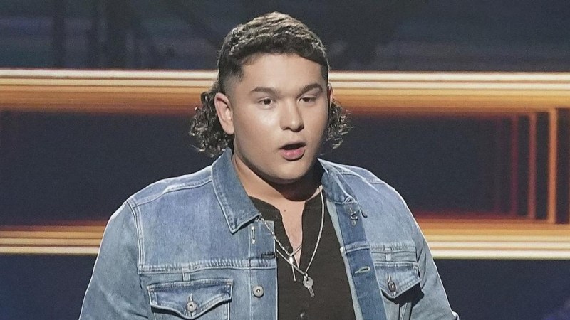 American Idol contestant Caleb Kennedy wears a blue denim jacket onstage