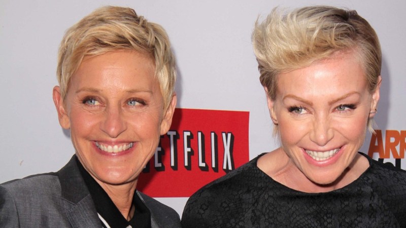 Ellen DeGeneres and Portia de Rossi smile for the camera at a premiere