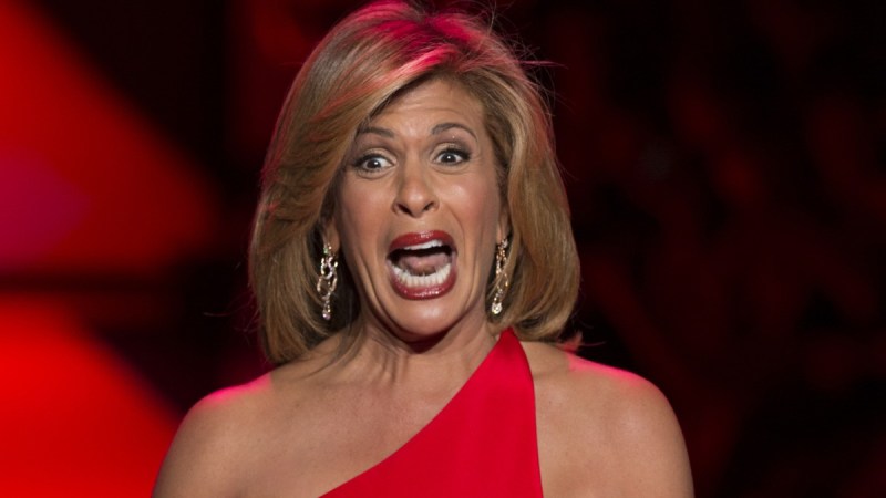 Hoda Kotb pulls a dramatic expression while walking the runway in a red dress