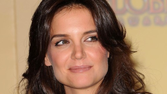 Katie Holmes looks to the side as she smiles slightly