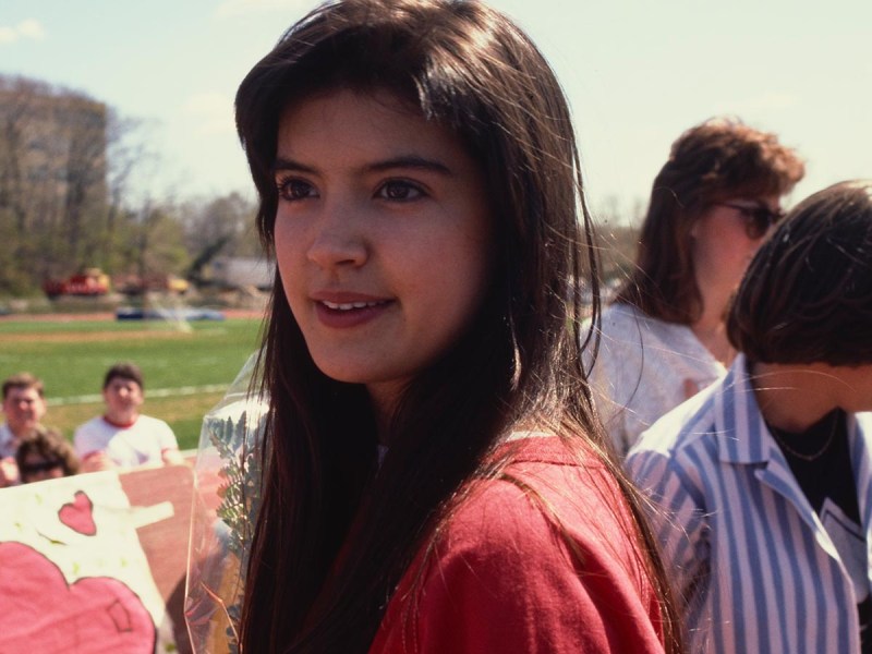 Phoebe Cates in 1986 at a St. John's football game, wearing a red sweatshirt