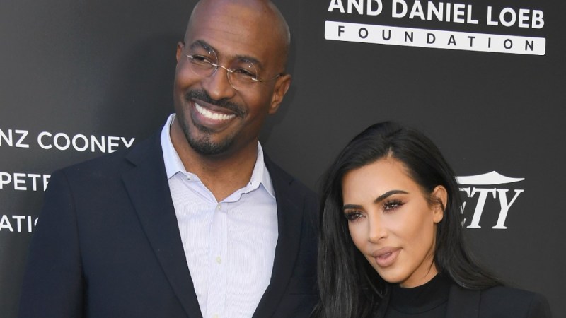 Van Jones, in a black suit, poses next to Kim Kardashian, also dressed in black