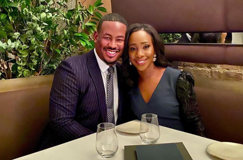 Abby Phillip and husband Marcus Richardson sitting at a formal dinner table and smiling.