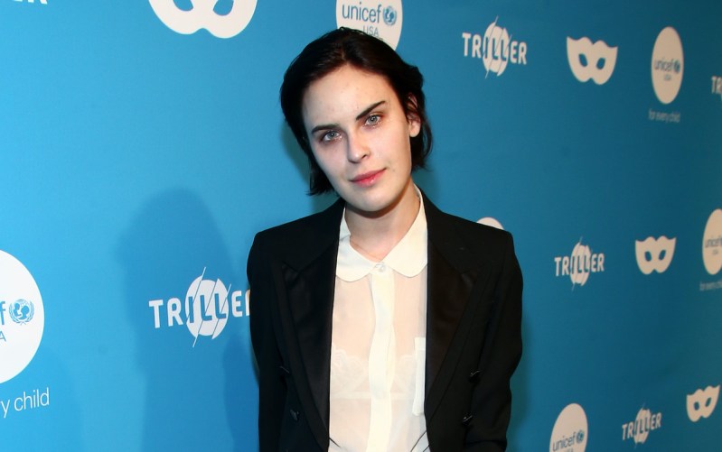 Tallulah Willis smiling in a black coat and white shirt