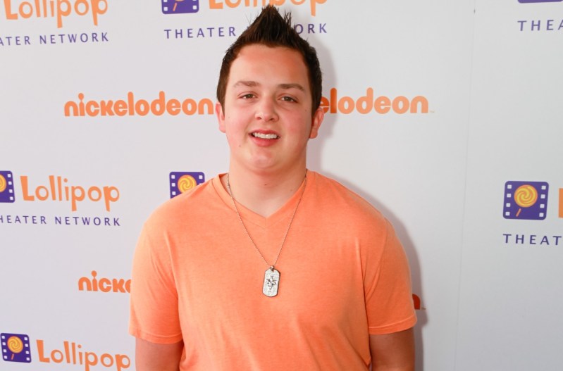 Noah Munck in 2011 wearing an orange shirt and smiling.