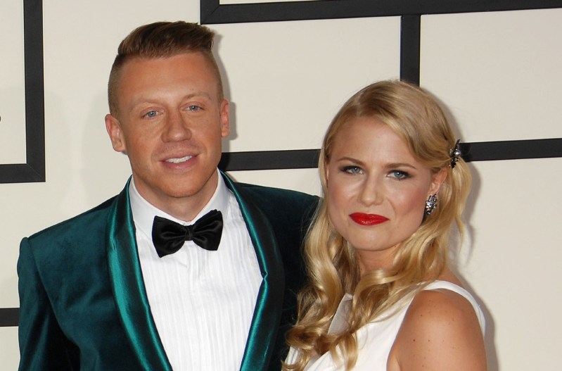 Macklemore and his wife, Tricia Davis at the Grammys in 2015. He's wearing a green suit; she's wearing a white dress.