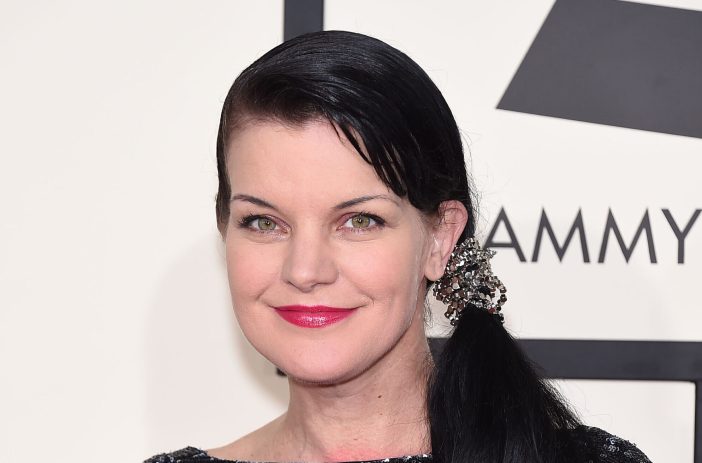 Pauley Perrette wearing a side ponytail and red lipstick at the Grammy Awards in 2015