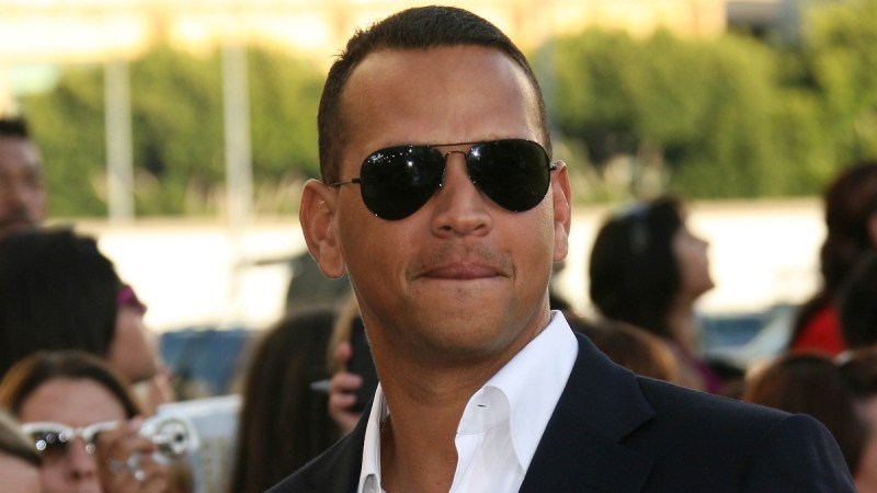 Alex Rodriguez wears a black suit and white shirt to a movie premiere