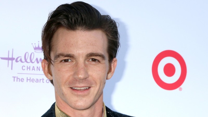 Drake Bell wears a dark suit jacket on the red carpet