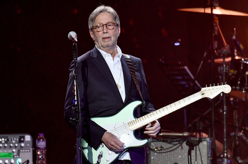 Eric Clapton playing guitar on stage in 2020