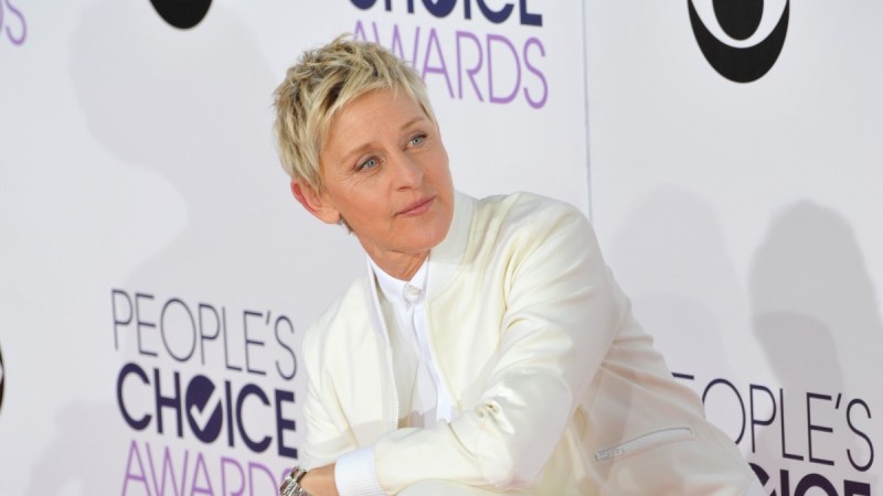 Ellen DeGeneres wears an all white suit on the red carpet