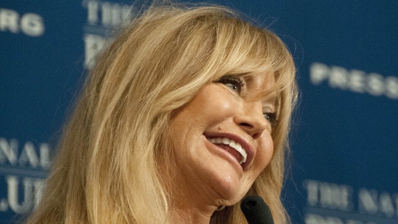 Goldie Hawn smiles and tilts her head to the side