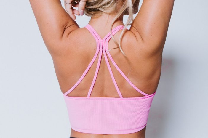 Image of woman wearing a pink sports bra.