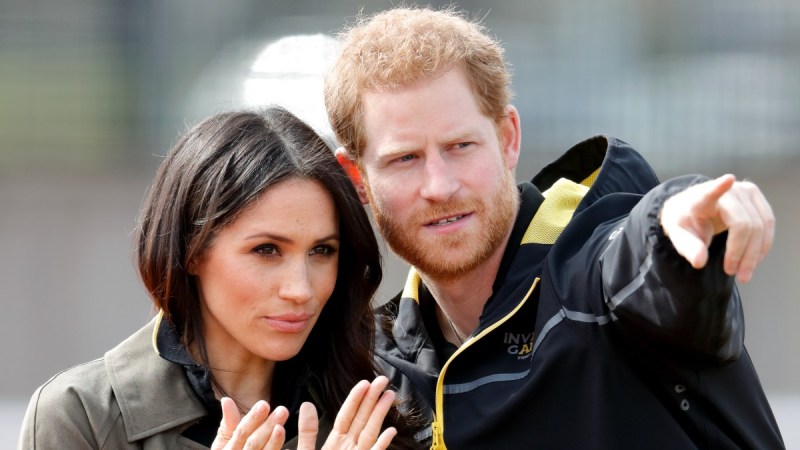 Meghan Markle claps as Prince Harry points to something off camera