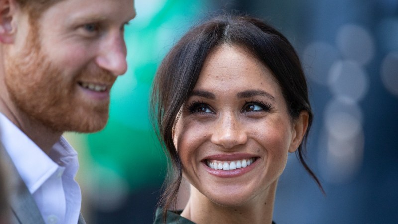 Prince Harry and Meghan Markle smile during a royal event