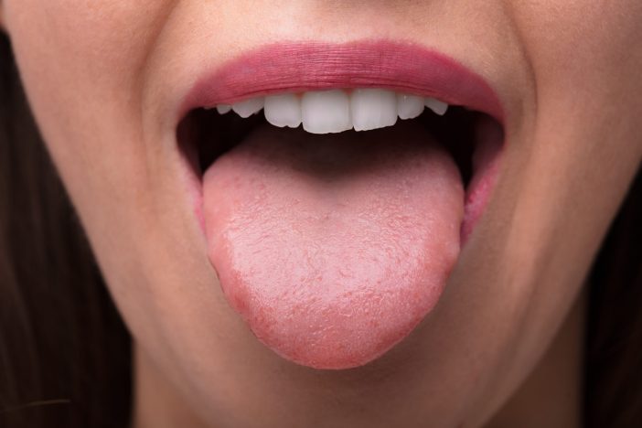 Image of woman stick out her tongue.