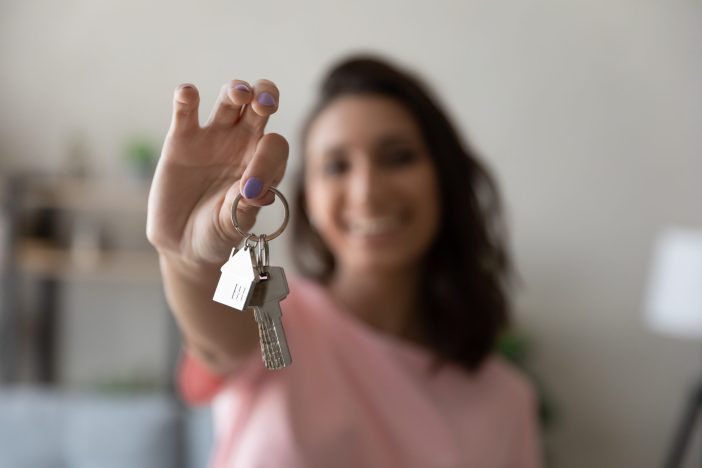 Image of a woman holding up a pair of keys.