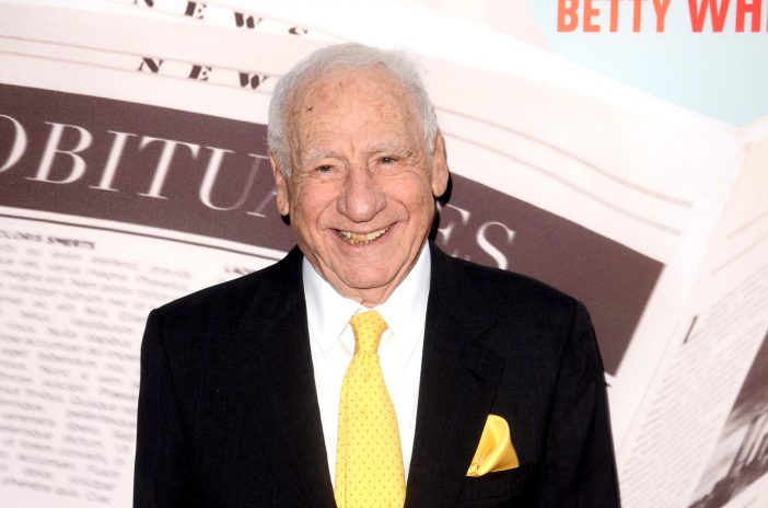 Mel Brooks wearing a suit and yellow tie