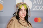 Billie Eilish looking side-eyed at a red carpet event.