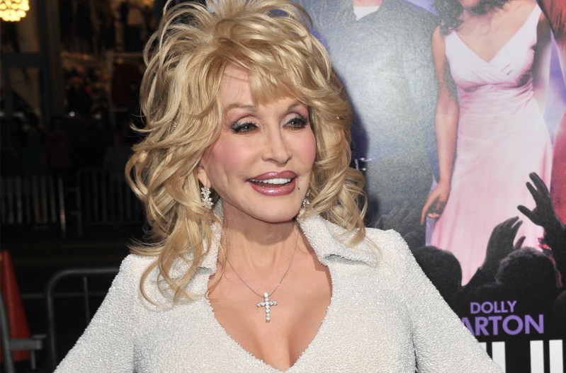 Dolly Parton smiling in a low-cut dress.