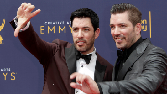 Drew and Jonathan Scott pose for pictures at the Emmy Awards red carpet