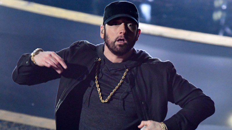 Eminem performs onstage while wearing an all black outfit