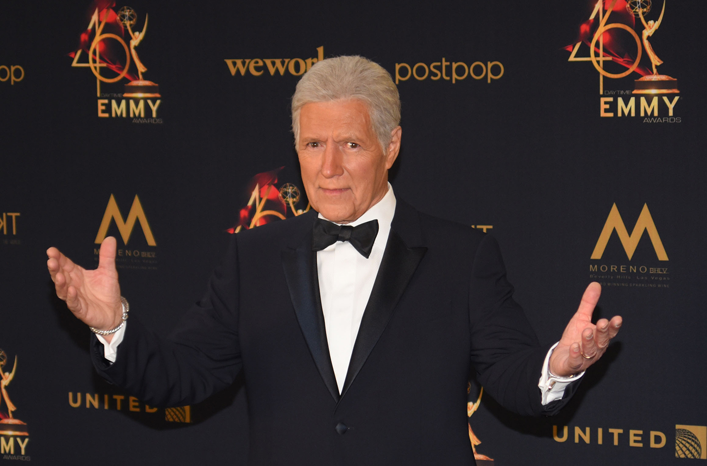 Alex Trebek shrugging and putting his hands up