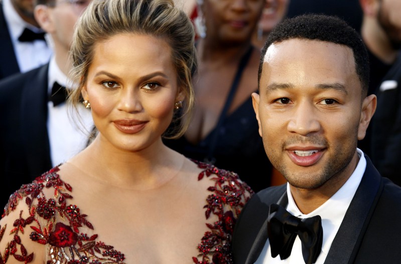 Chrissy Tiegen on the left, John Legend on the right, together at an event in formal wear