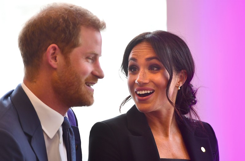 Meghan Markle on the right, looking and laughing with Prince Harry