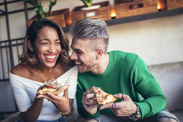 Couple eating pizza.