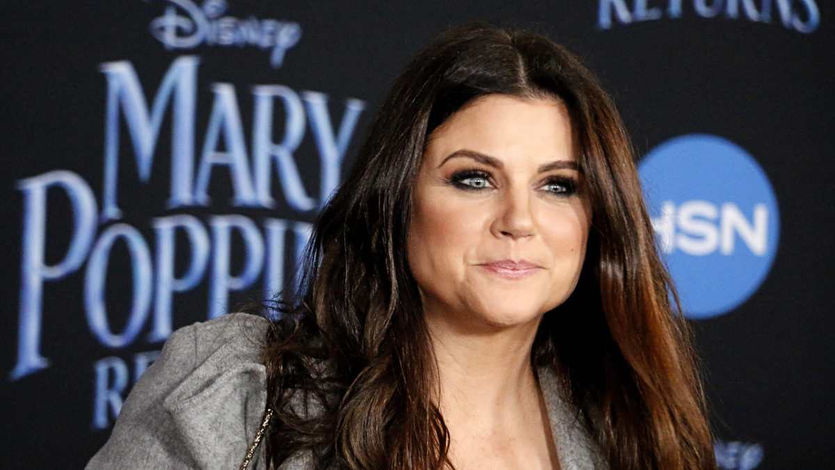 (Tinseltown/Shutterstock.com) Tiffany Thiessen smiling in grey coat at Dolby Theatre