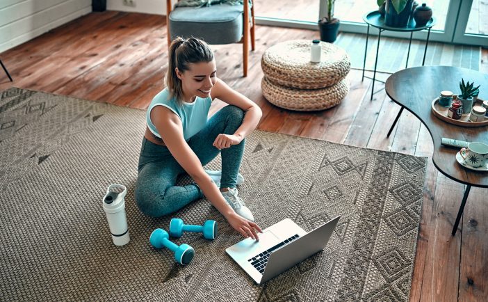 Image of a woman doing online workout videos.