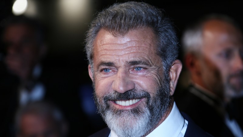 (Denis Makarenko/Shutterstock.com) Mel Gibson smiles in a suit and tie