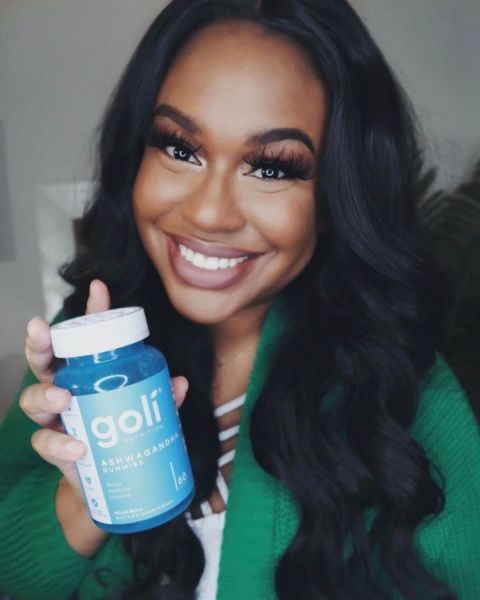 Woman holding Goli Ashwaganda gummies