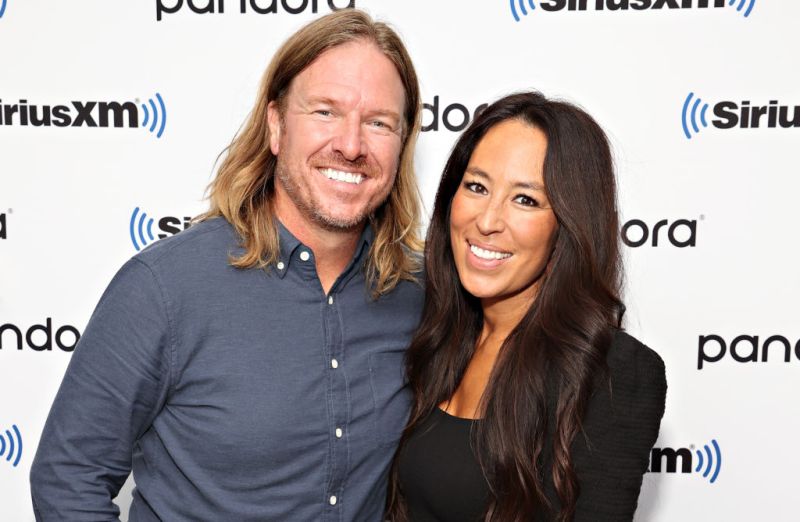 Chip Gaines on the left with long hair, standing with Joanna Gaines.