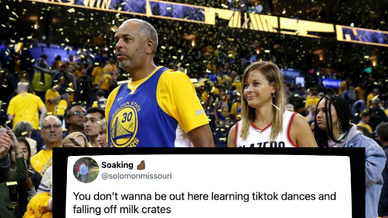 Dell Curry, in a Golden State Warriors jersey, and Sonya Curry, in a Blazers jersey, walk past the court