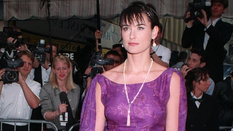 Demi Moore wears a purple gown while attending the Cannes Film Festival in 1997