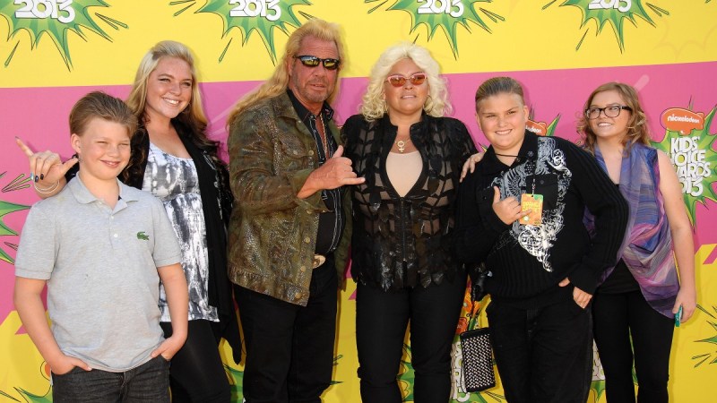 Dog the bounty hunter and his late wife Beth Chapman pose with the couple's four children on the red carpet
