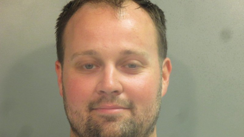 Josh Duggar poses for his mug shot
