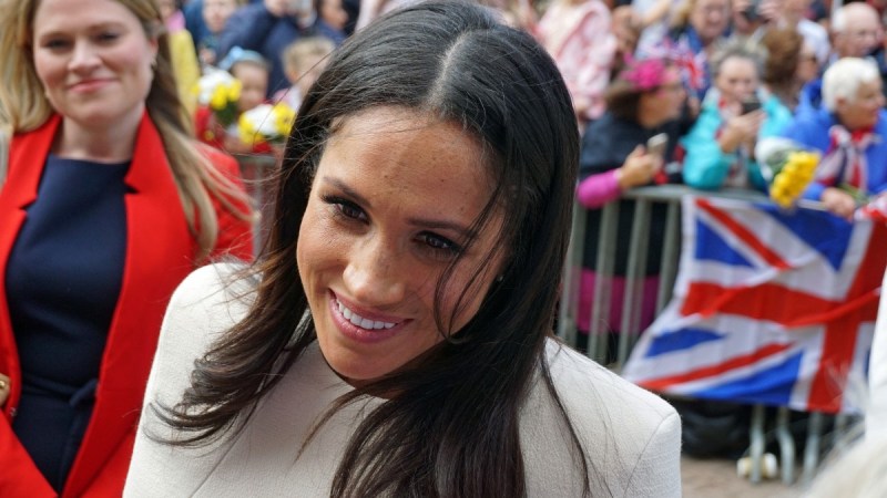 Meghan Markle wears a white coat as she greets a crowd of well wishers
