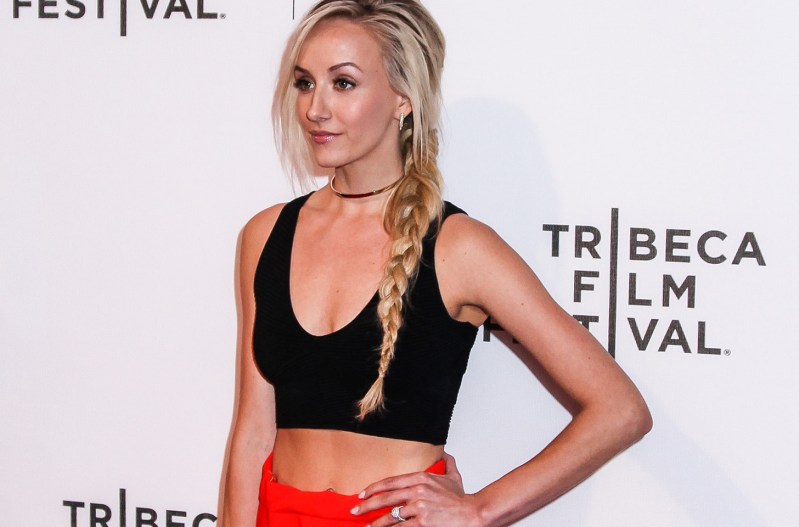Nastia Liukin with her hand on her hip at a red csarpet event.
