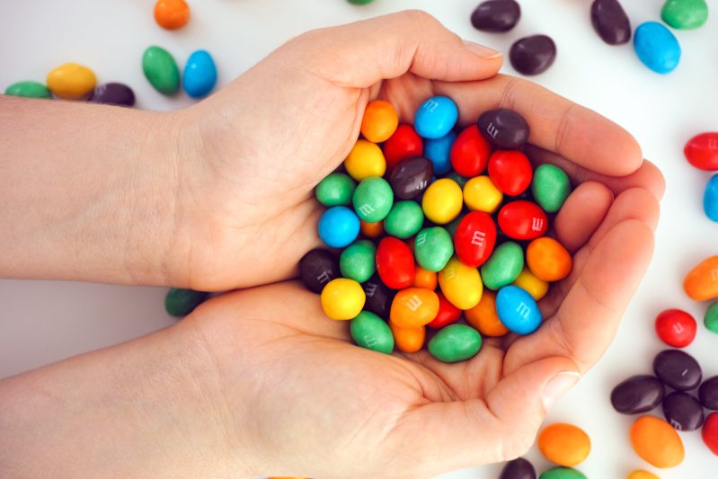 Image of hands holding M&M's