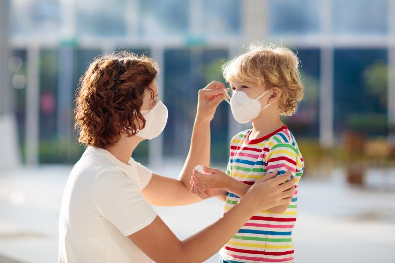 Image of mom helping son with mask