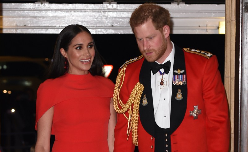 Prince Harry and Meghan Markle in red outfits